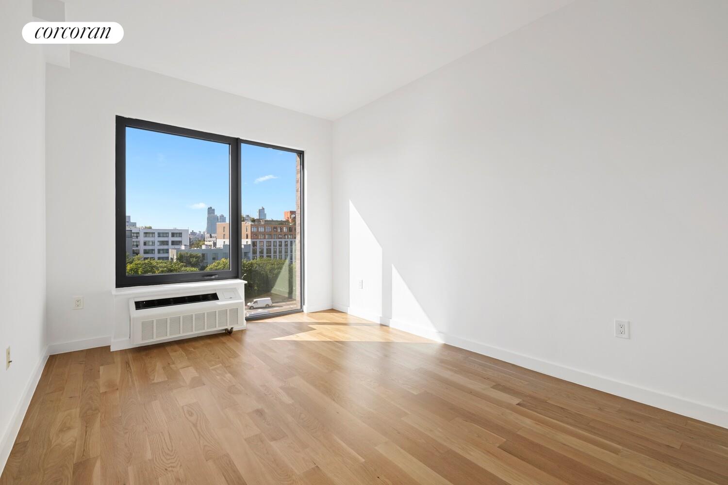 123 Hope Street, Unit 7R Brooklyn, NY 11211 - Photo 8 of 15 a view of a room with wooden floor and window