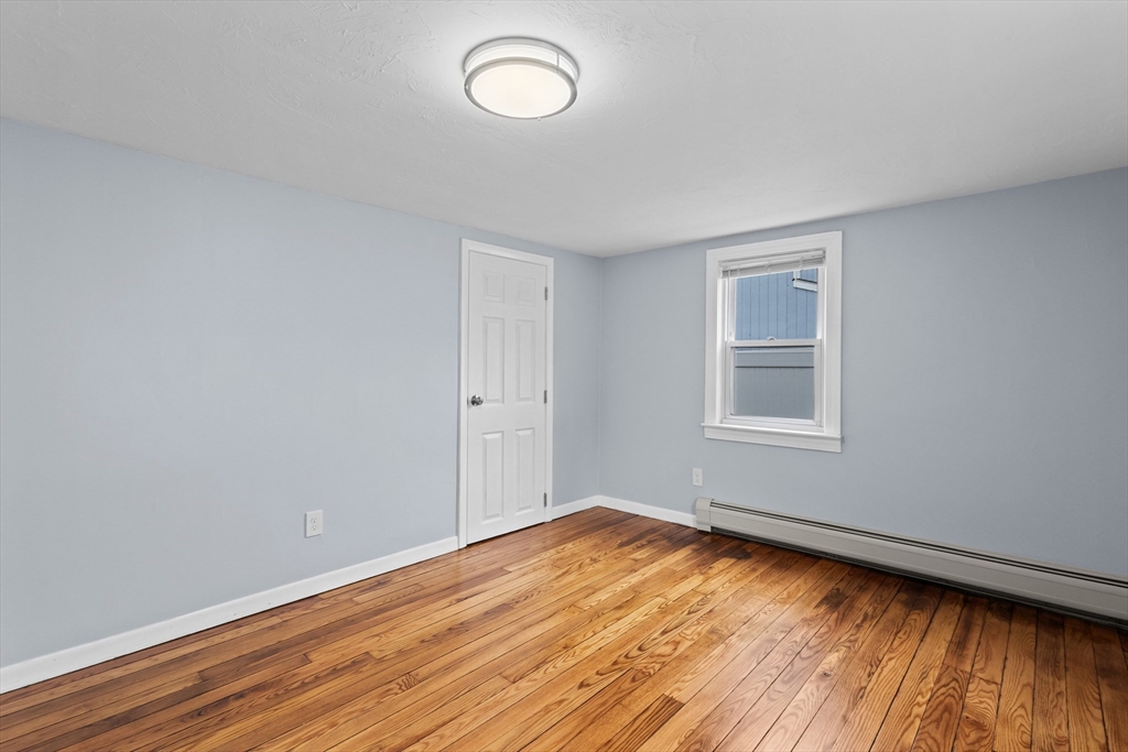 5 Phoenix Street Worcester, MA 01604 - Photo 26 of 32 wooden floor in an empty room with a window