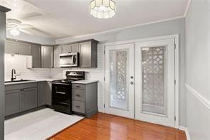 1822 North Rock Springs Road Northeast, Unit 7 Atlanta, GA 30324 - Photo 7 of 21 a kitchen with stainless steel appliances granite countertop a stove top oven a sink dishwasher a dining table and chairs with wooden floor