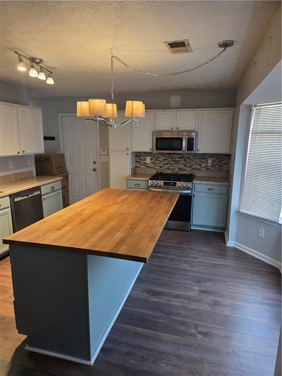 2549 Rainbow Creek Drive Decatur, GA 30034 - Photo 13 of 57 a large kitchen with wooden floor and stainless steel appliances