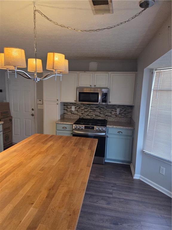 2549 Rainbow Creek Drive Decatur, GA 30034 - Photo 22 of 57 a kitchen with stainless steel appliances granite countertop a stove a sink and a refrigerator
