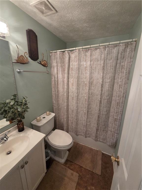 2549 Rainbow Creek Drive Decatur, GA 30034 - Photo 49 of 57 a bathroom with a sink a toilet and shower curtain