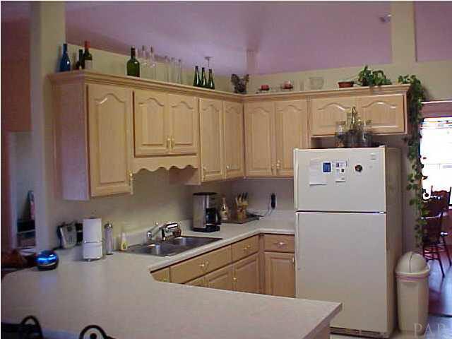 7155 Jennifer Road Pensacola, FL 32526 - Photo 6 of 14 PLENTY OF CABINET SPACE, WITH WRAP AROUND BAR.