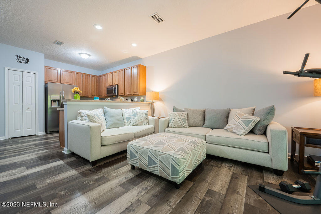 8683 Ribbon Falls Lane Jacksonville, FL 32244 - Photo 2 of 43 a living room with furniture and a wooden floor