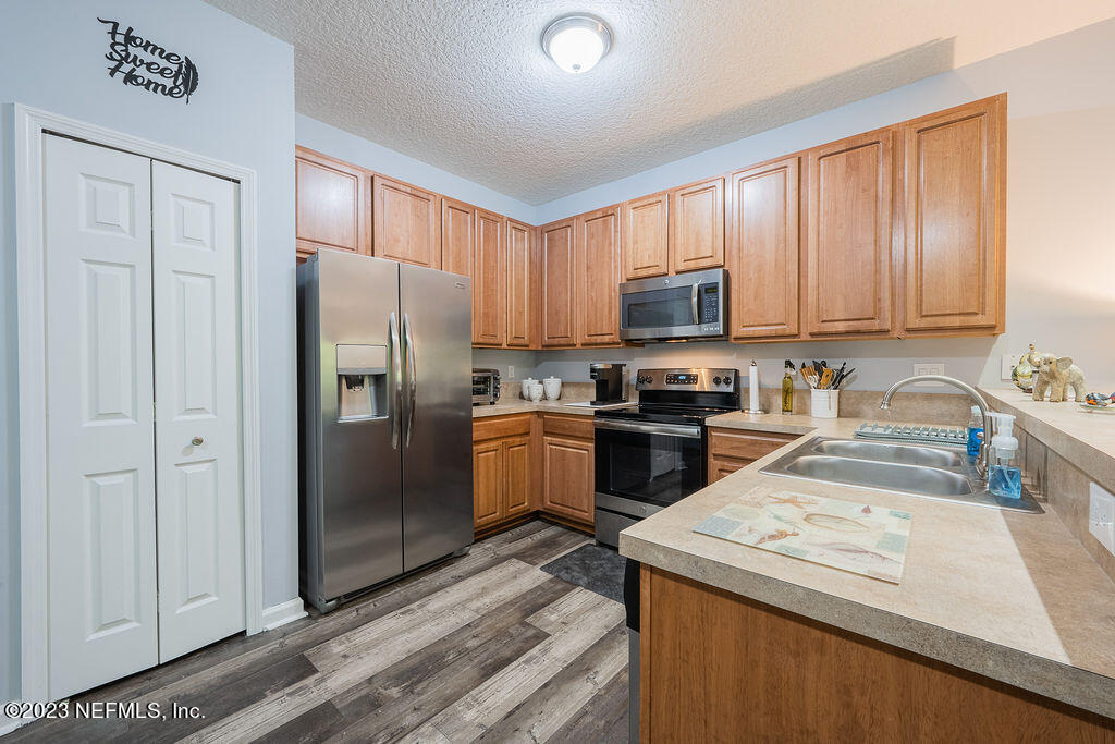 8683 Ribbon Falls Lane Jacksonville, FL 32244 - Photo 23 of 43 a kitchen with a refrigerator sink and cabinets