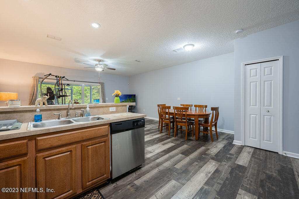 8683 Ribbon Falls Lane Jacksonville, FL 32244 - Photo 24 of 43 a kitchen with a sink and chairs