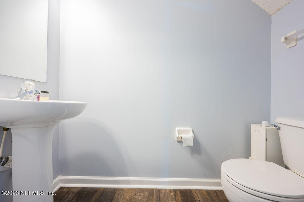 8683 Ribbon Falls Lane Jacksonville, FL 32244 - Photo 25 of 43 a bathroom with a sink a toilet and mirror