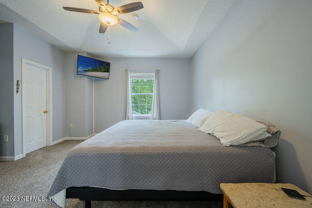 8683 Ribbon Falls Lane Jacksonville, FL 32244 - Photo 29 of 43 a bedroom with a bed and a window