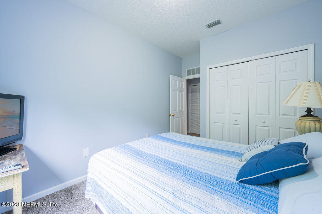 8683 Ribbon Falls Lane Jacksonville, FL 32244 - Photo 42 of 43 a bedroom with a bed and a television