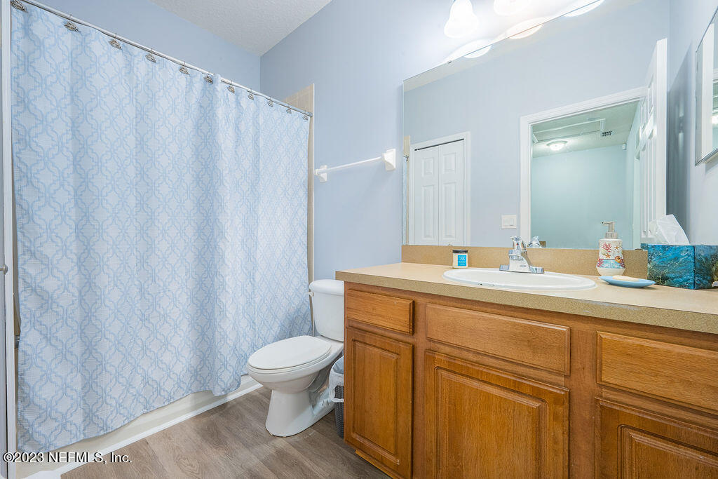 8683 Ribbon Falls Lane Jacksonville, FL 32244 - Photo 43 of 43 a bathroom with a sink a toilet and a mirror