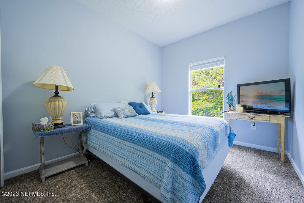 8683 Ribbon Falls Lane Jacksonville, FL 32244 - Photo 7 of 43 a bedroom with a bed and a flat screen tv