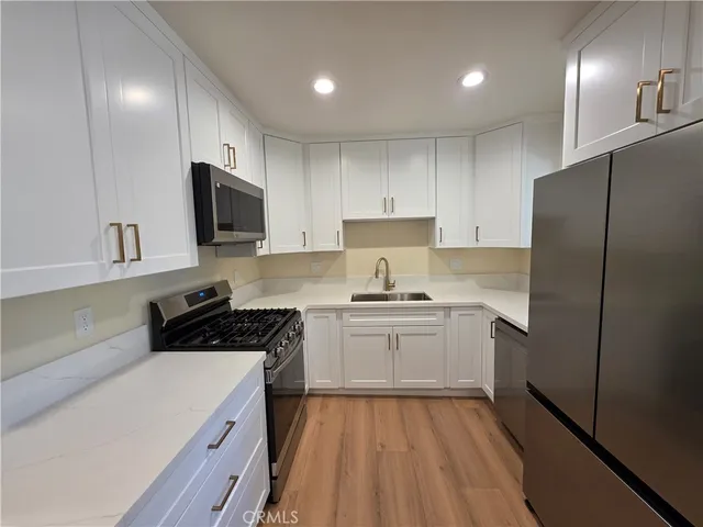 a kitchen with a refrigerator stove and sink