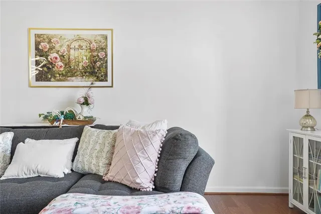 a living room with furniture and painting on the wall