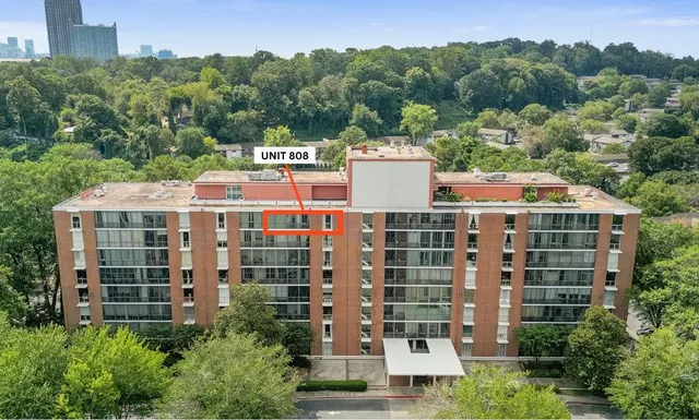 a view of a large building with a yard