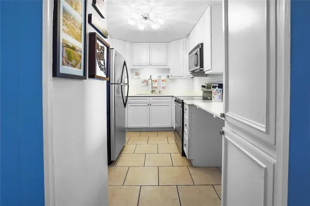 a kitchen with stainless steel appliances granite countertop a refrigerator and a stove