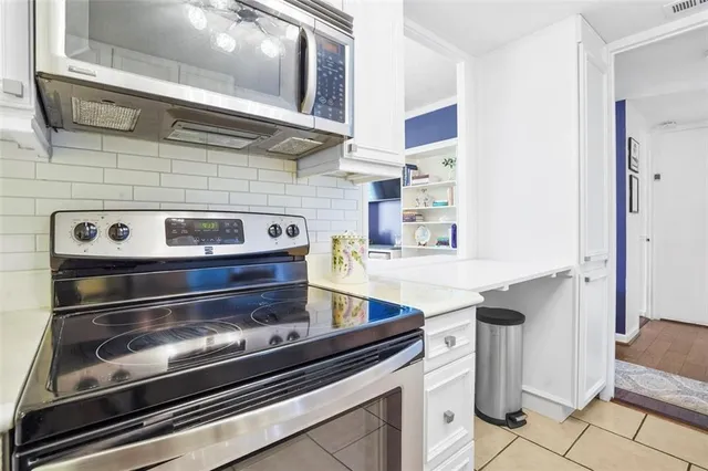 a stove top oven sitting inside of a kitchen
