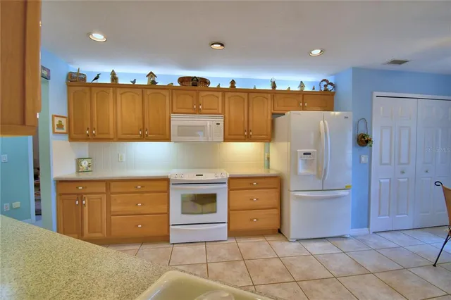 a view of a dining room with furniture and a chandelier
