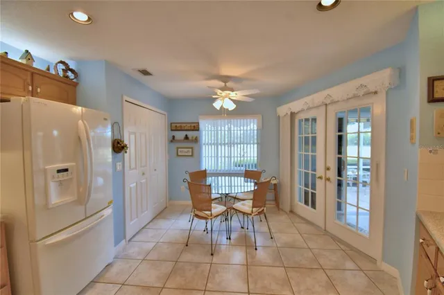 a kitchen with stainless steel appliances kitchen island granite countertop a table and chairs in it