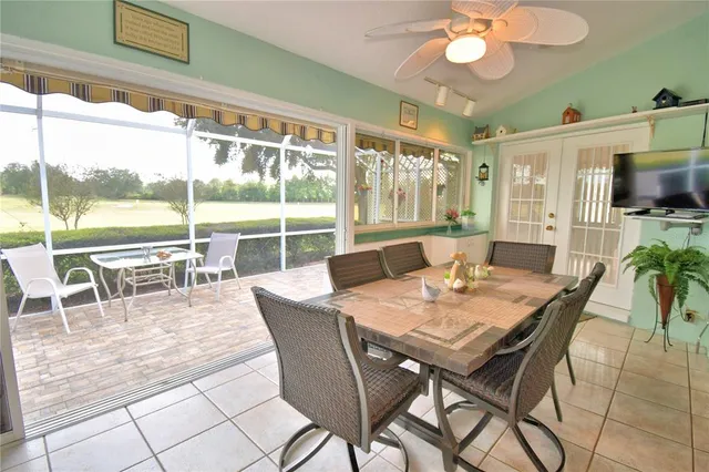 a view of a dining room with furniture large windows and wooden floor