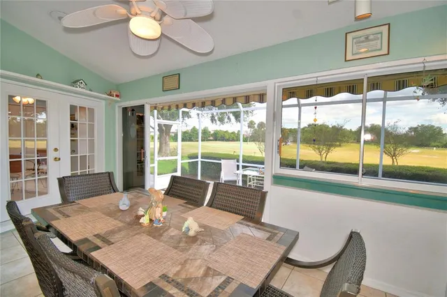 a view of a chair and table in the patio with a yard