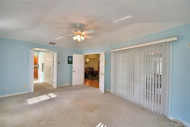 a view of a hallway with wooden floor and windows