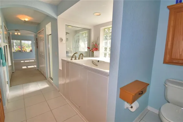 a bathroom with a sink a tub and mirror