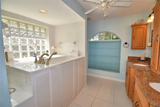 a bathroom with a granite countertop sink a mirror and a shower