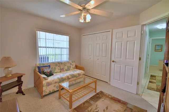 a living room with furniture and a bookshelf