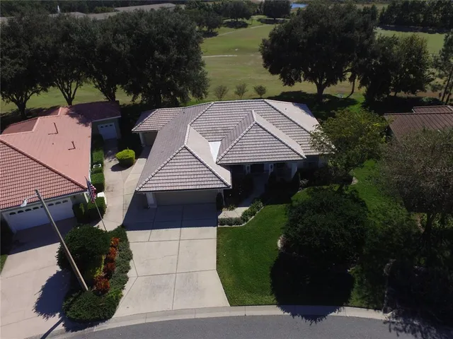 an aerial view of multiple houses with yard