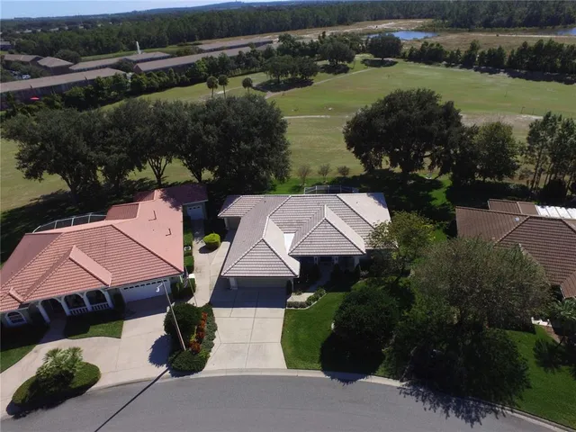 an aerial view of a house with garden space and street view