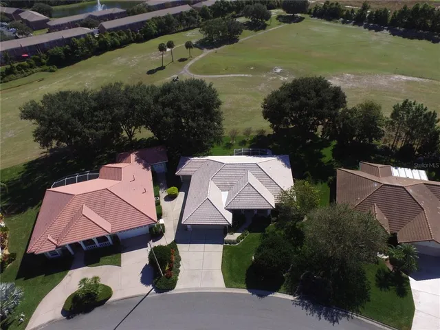 an aerial view of a house with a yard and garden