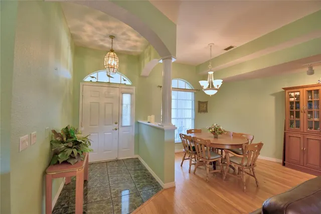 a view of a dining room with furniture wooden floor and chandelier