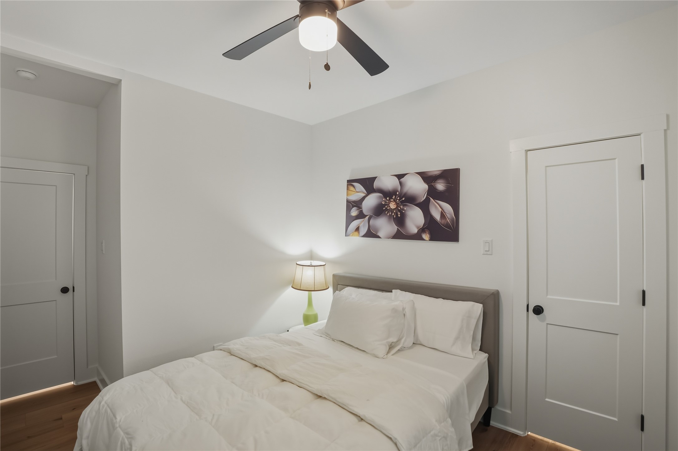 8017 Cora Street, Unit B Houston, TX 77088 - Photo 13 of 28 a bedroom with a large bed and a chandelier