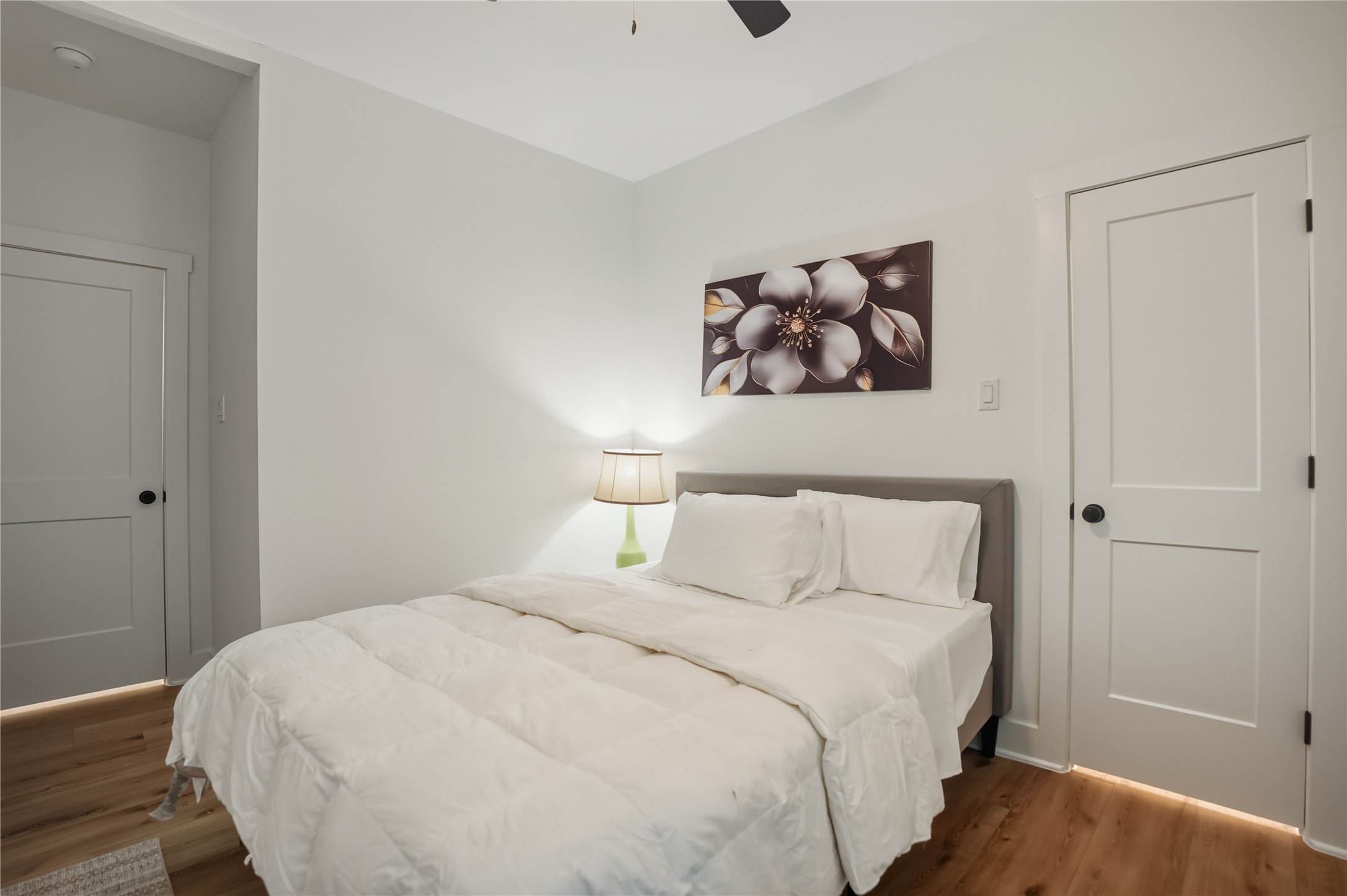 8017 Cora Street, Unit B Houston, TX 77088 - Photo 14 of 28 a bedroom with a bed and a wooden floor