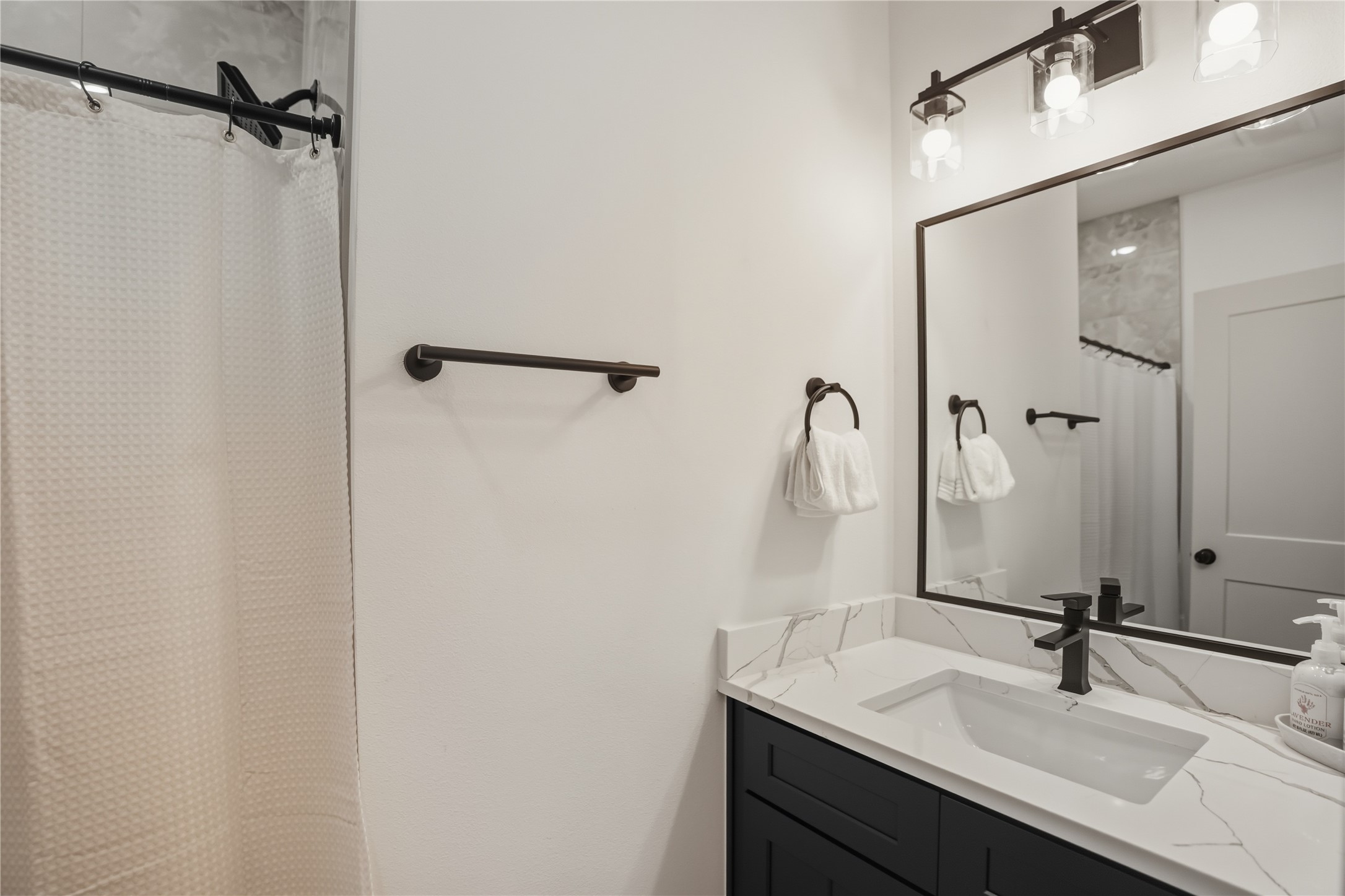 8017 Cora Street, Unit B Houston, TX 77088 - Photo 15 of 28 a bathroom with a sink and a mirror