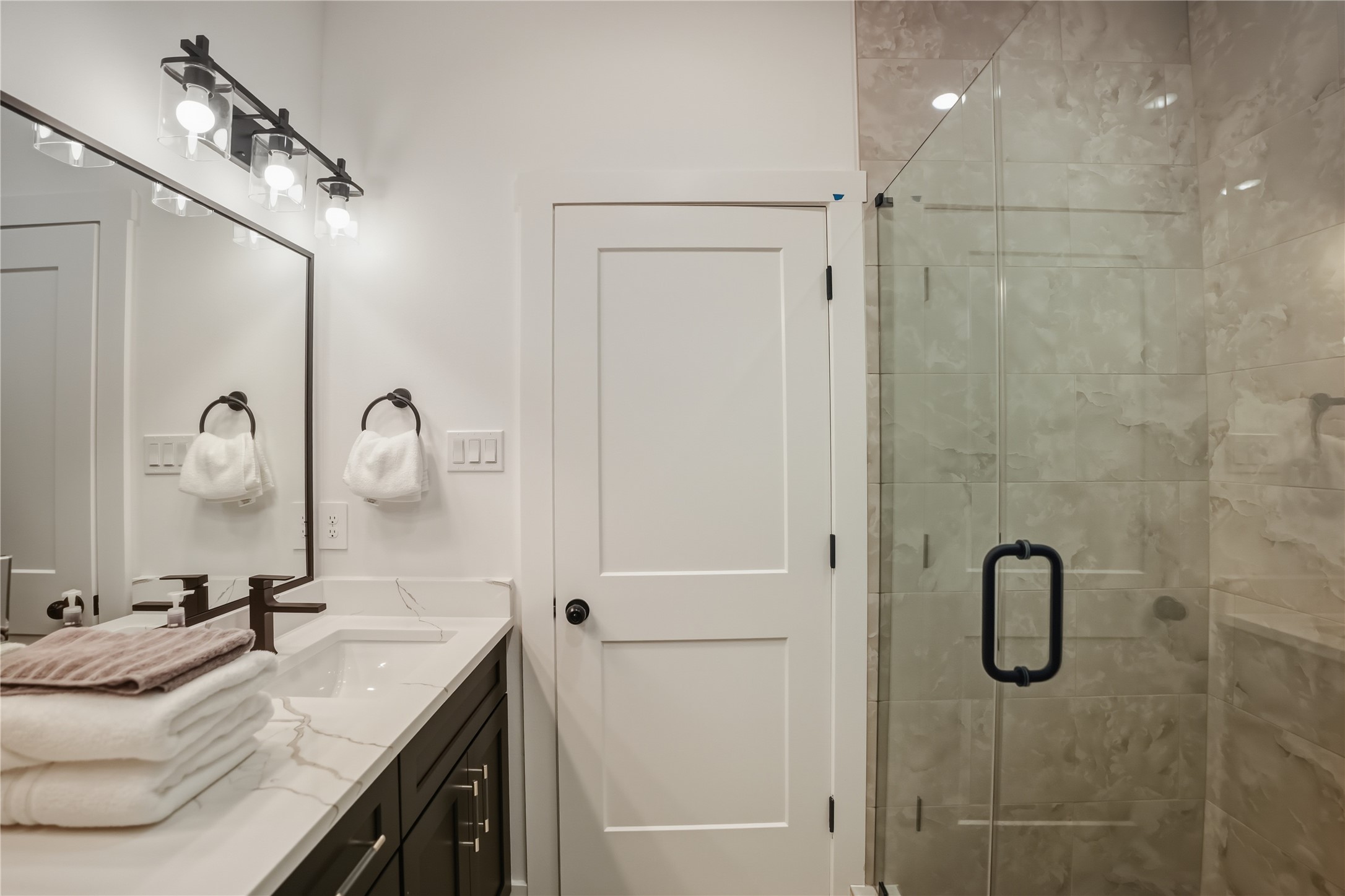 8017 Cora Street, Unit B Houston, TX 77088 - Photo 21 of 28 a bathroom with a granite countertop sink a shower and mirror