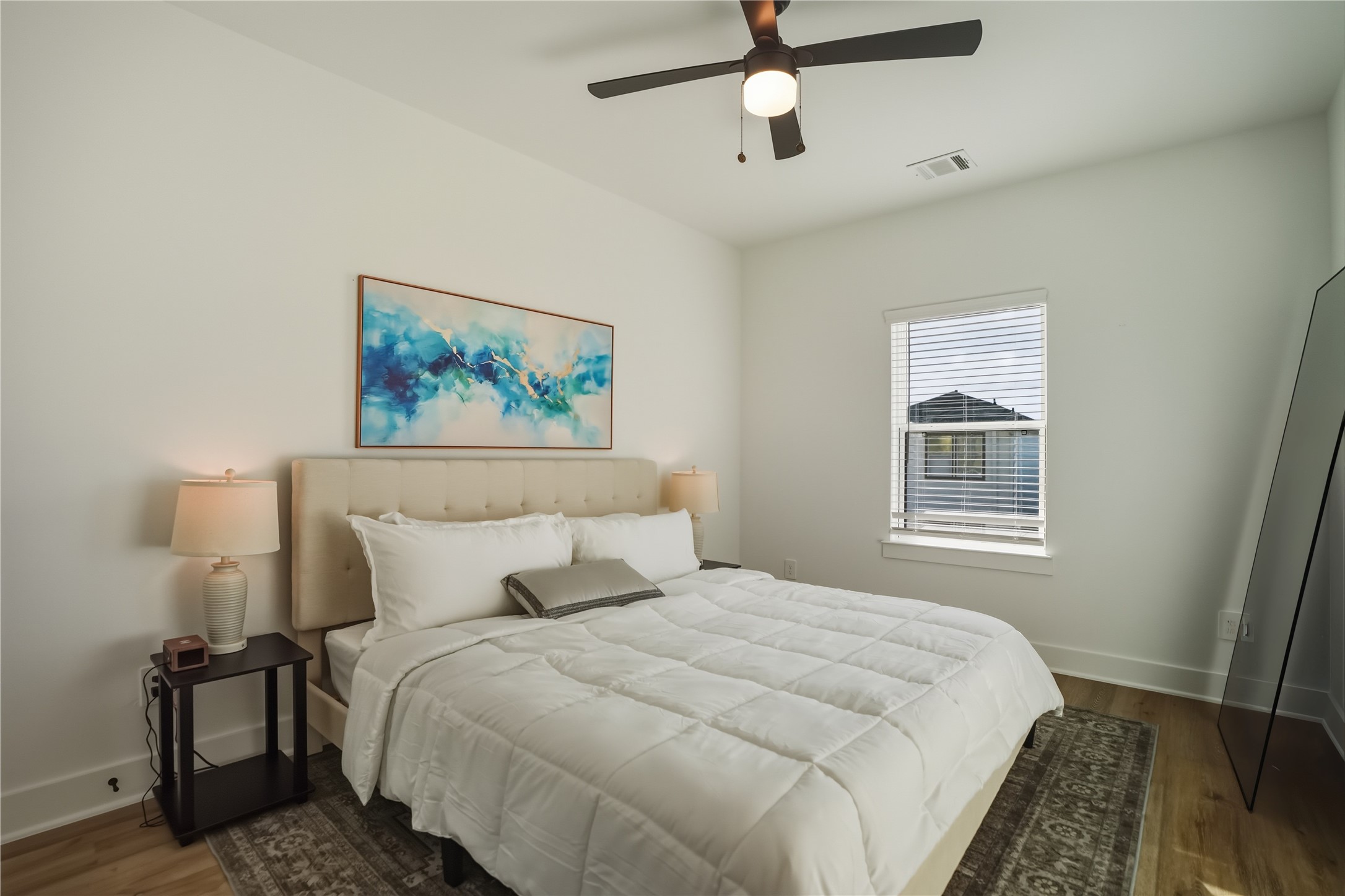 8017 Cora Street, Unit B Houston, TX 77088 - Photo 23 of 28 a bedroom with a bed and a painting on the wall