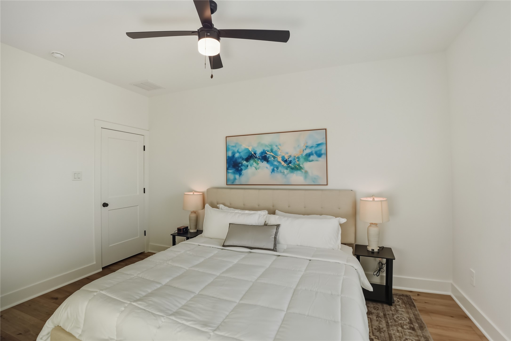 8017 Cora Street, Unit B Houston, TX 77088 - Photo 24 of 28 a bedroom with a bed and a painting on the wall