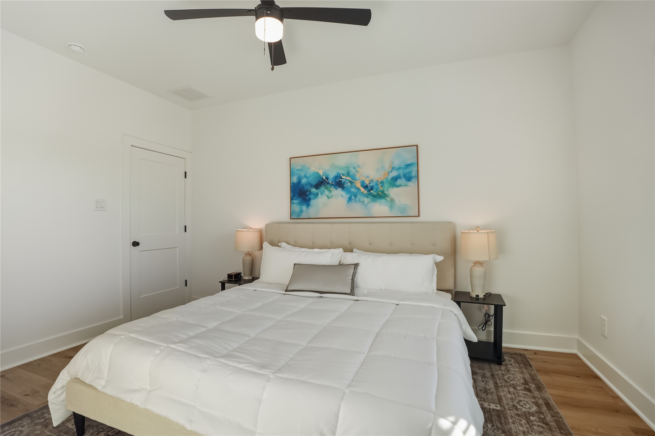 8017 Cora Street, Unit B Houston, TX 77088 - Photo 25 of 28 a bedroom with a bed and a painting on the wall