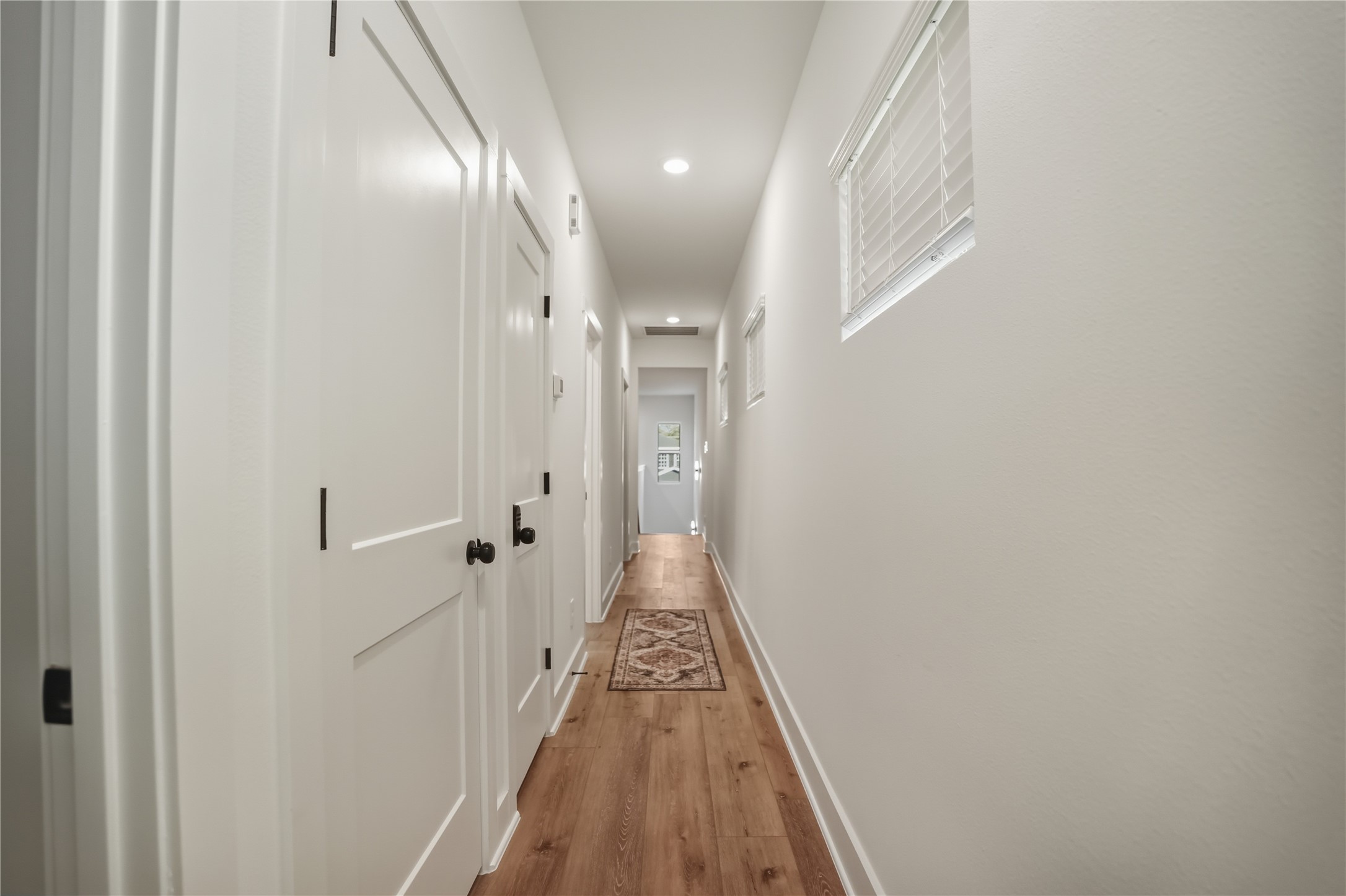 8017 Cora Street, Unit B Houston, TX 77088 - Photo 27 of 28 a view of a hallway with wooden floor and staircase
