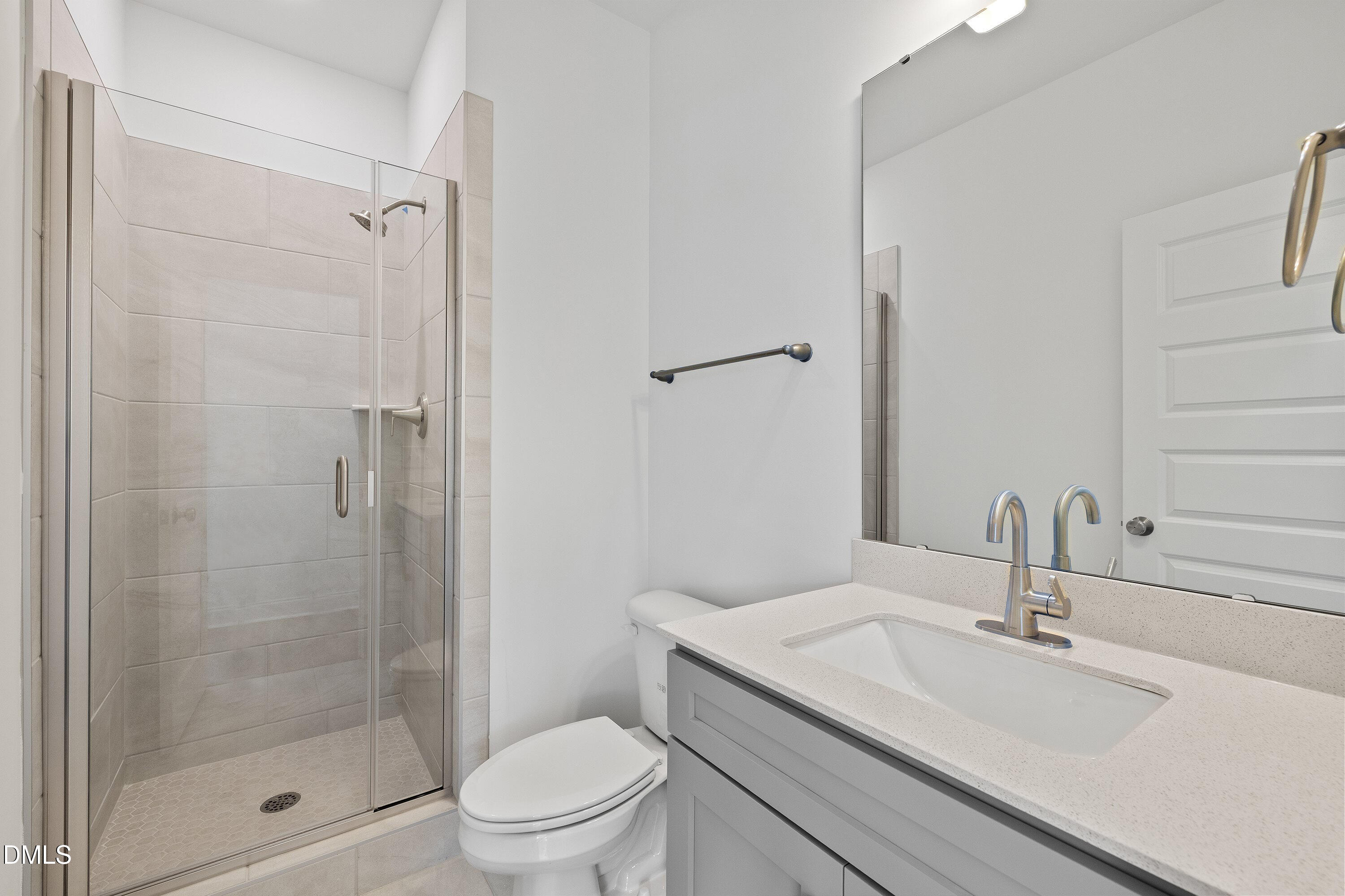 62 West Victoria Ridge Drive, Unit 19 Selma, NC 27576 - Photo 13 of 26 a bathroom with a sink a toilet and shower