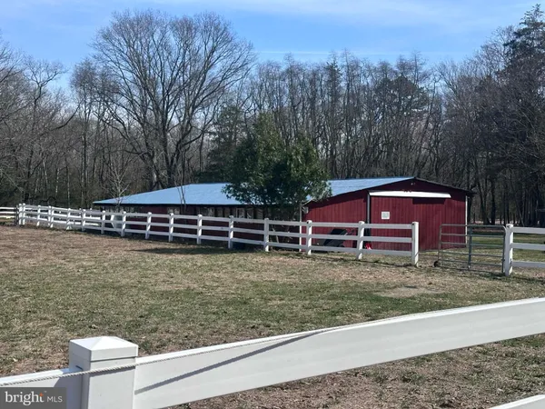 a view of a house with pool and a yard