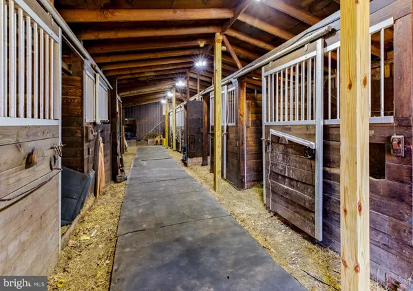 a view of water heater room with wooden floor