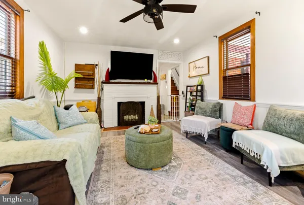 a living room with furniture a flat screen tv and a fireplace