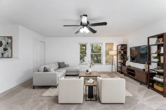a living room with furniture and a flat screen tv