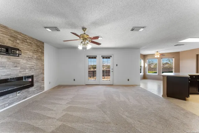 a view of an empty room with a fireplace