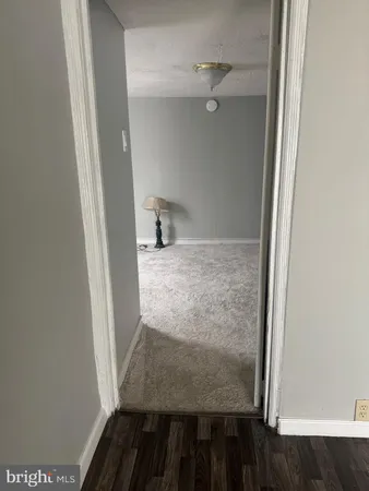 a room with wooden door and furniture