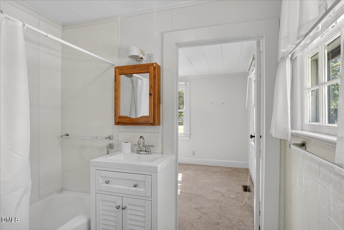 616 Roxboro Road Oxford, NC 27565 - Photo 19 of 38 a bathroom with a sink a vanity and a mirror