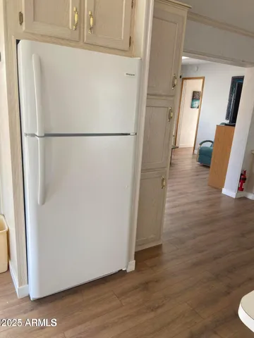 a view of a storage and utility room with wooden floor