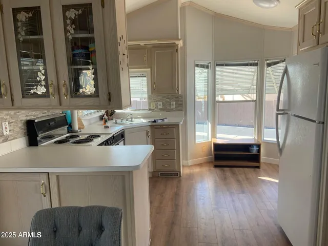 a kitchen with a sink appliances and cabinets